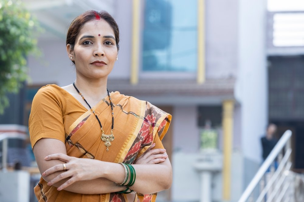 Confident,asian,female,looking,at,camera,with,folded,hands.